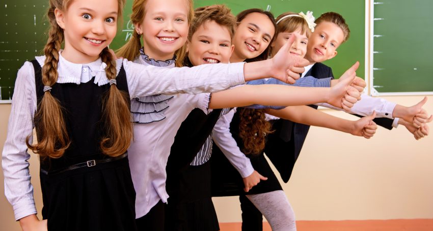 Happy schoolchildren at a classroom. Education.