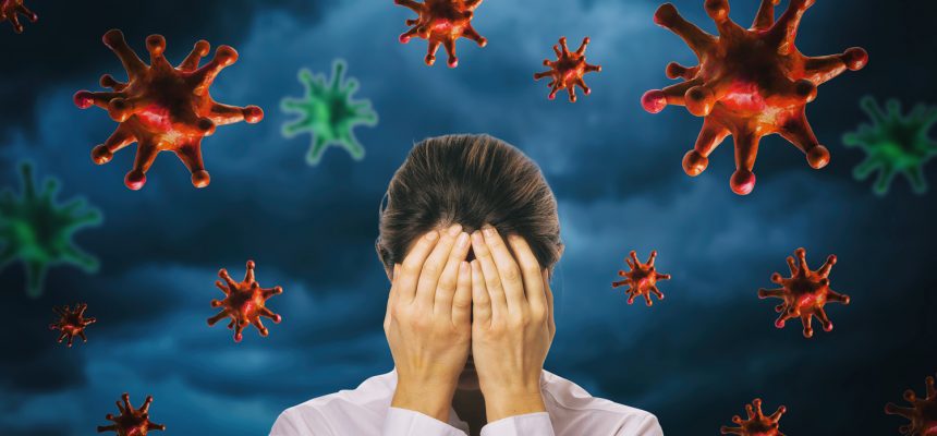 The girl closed her face with her hands against the background of a thunderstorm sky with a coronavirus. The concept of fear of the pandemic COVID-19